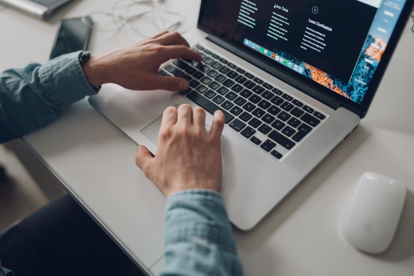 Image of a web developer working on a laptop