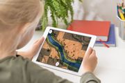 Image of girl with ipad playing the rocks and crystals app